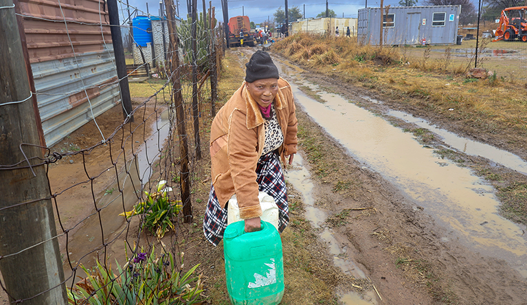 Elderly women carry water in their daily struggle for a reliable supply in Mimosa Township, Delmas. Photograph: Rodney Hlatshwayo.