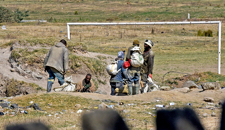 Zama zamas emerge from an old mine shaft at Wattville Dam, across the road from the Mandleni informal settlement in Benoni, South Africa, on the East Rand, on 28 August 2026. Many miners then proceed to the informal settlement, where gold is extracted.

The area is part of an illicit mining network where dozens of young people are reportedly deceived and coerced with promises of decent jobs before being drawn into illegal mining by mining kingpins and gang leaders. Photograph: Tebogo Letsie/SA|AJP