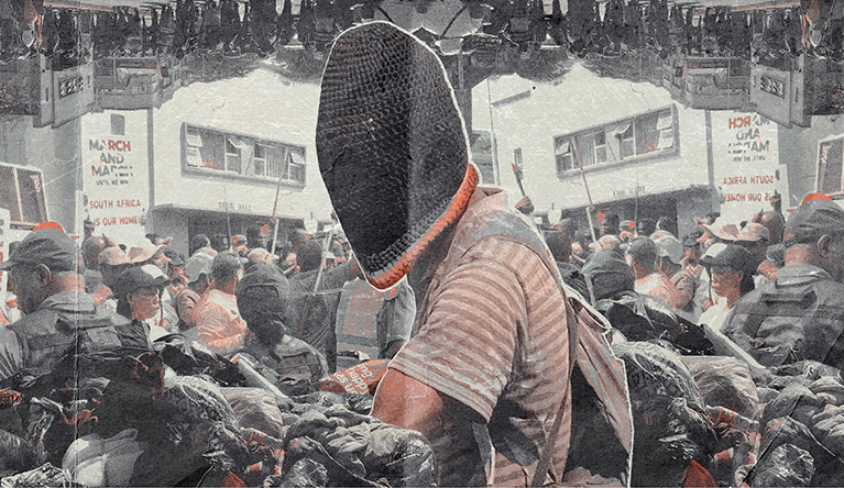 An immigrant displaced to Che Guevara Road in Durban holds up papers. Almost all people displaced to the encampment were documented. (Photo: Joseph Bracken, GroundUp)