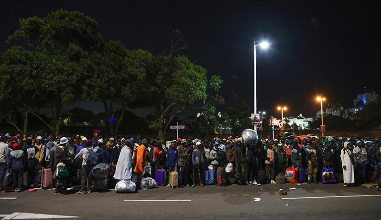 Undocumented Malawian nationals queue outside a repatriation centre in Durban’s city centre for processing ahead of their voluntary return to Malawi on 23 June 2026. Photo: Felix Dlangamandla/Daily Maverick